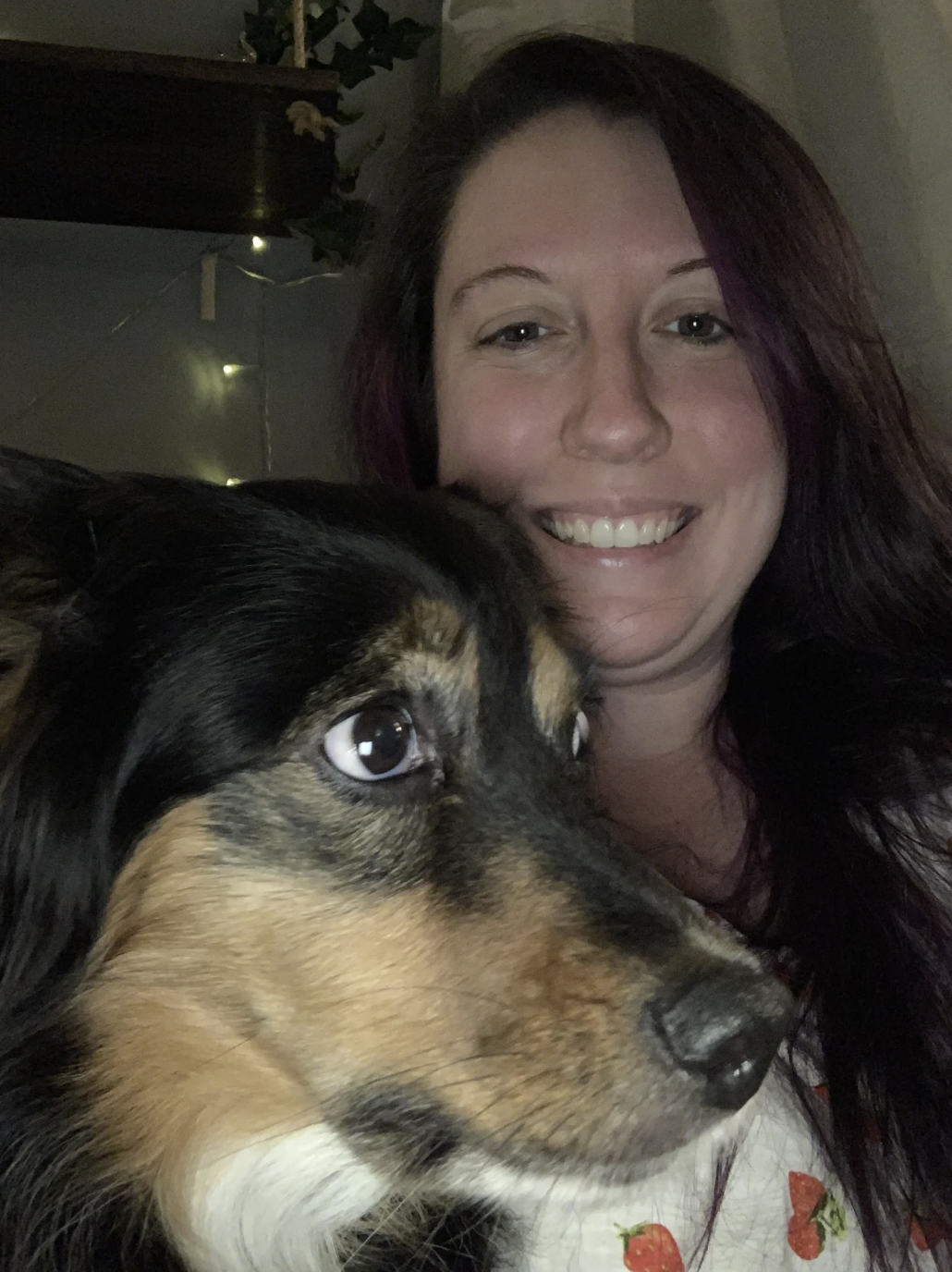 Amber smiling with one of her dogs.